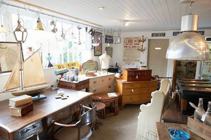 Wide view inside Bridge Antiques Centre showing furniture, lighting and curiosities