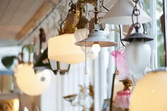 Vintage pendant lights and chandeliers hanging in Bridge Antiques Centre, Truro